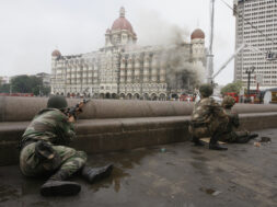 Indian army soldiers take position during a gun battle at Taj Mahal hotel in Mumbai