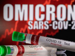 FILE PHOTO: Illustration shows test tubes labelled “COVID-19 Test Positive” in front of displayed words “OMICRON SARS-COV-2