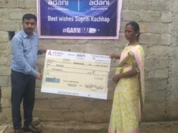 Family of Supriti Kacchap receiving cheque from Adani Foundation