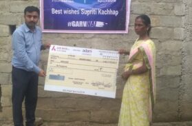 Family of Supriti Kacchap receiving cheque from Adani Foundation