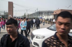 Workers on their lunch break leave the Foxconn plant in Zhengzhou, China, on Oct. 19, 2015. (Gilles Sabri/The New York Times)
