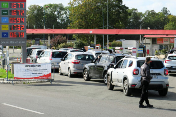 FILE PHOTO: Car drivers queue to fill their fuel tank at gasoline pumps at  Auchan gas station in Petite-Foret