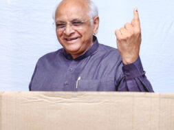 Gujarat Chief Minister Bhupendra Patel shows his ink-marked finger as he casts his vote for the local self-governance election a