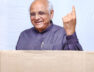 Gujarat Chief Minister Bhupendra Patel shows his ink-marked finger as he casts his vote for the local self-governance election a
